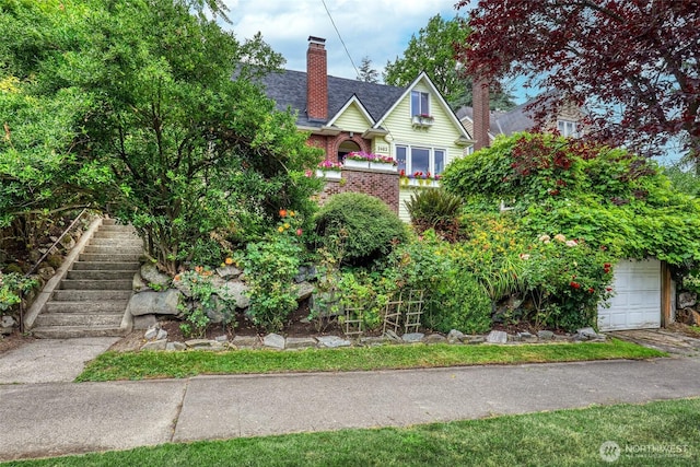 2463 26th Ave E, Seattle, WA 98112 - view of front facade with a garage, a chimney, and stairs