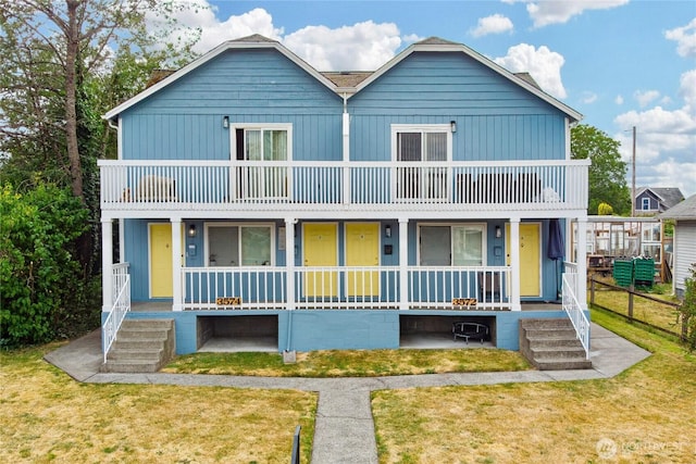 3572-3574 E F St, Tacoma, WA 98404 - view of front facade with a porch, a balcony, and a front yard