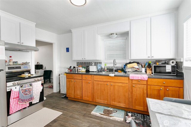 3572-3574 E F St, Tacoma, WA 98404 - kitchen featuring stainless steel electric stove, black microwave, under cabinet range hood, dark wood-style flooring, and white cabinetry