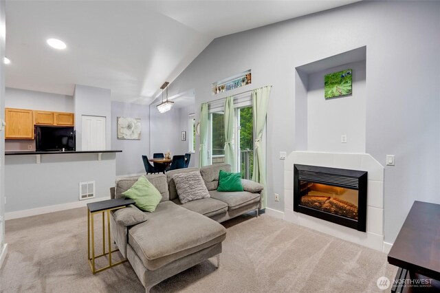 5809 Highway Pl Unit B304, Everett, WA 98203 - living area with light carpet, vaulted ceiling, a tile fireplace, and recessed lighting