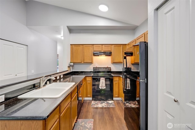 5809 Highway Pl Unit B304, Everett, WA 98203 - kitchen featuring black appliances, vaulted ceiling, under cabinet range hood, dark wood finished floors, and a peninsula