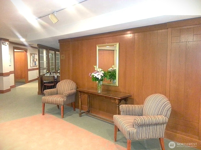 1750 152nd Ave NE Unit C310, Bellevue, WA 98007 - sitting room featuring rail lighting, wooden walls, and carpet