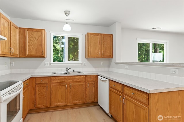 12904 159th St E, Puyallup, WA 98374 - kitchen with white appliances, a peninsula, light wood-type flooring, and light countertops