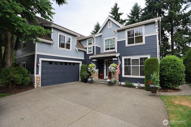4442 Prestwick Ln SE, Lacey, WA 98513 - view of front of house featuring an attached garage, concrete driveway, and stone siding