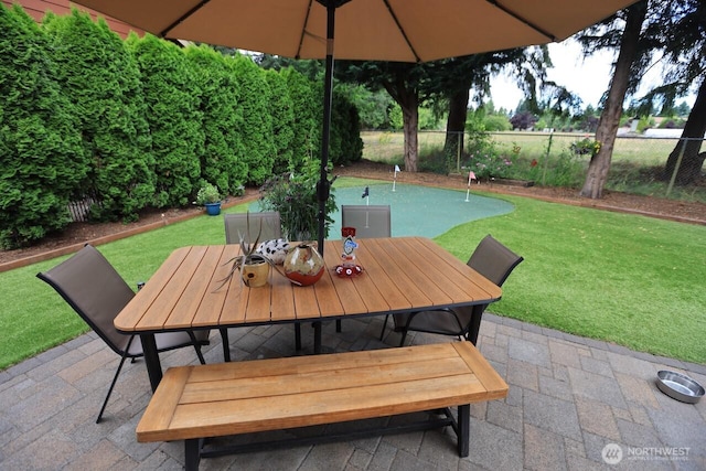 4442 Prestwick Ln SE, Lacey, WA 98513 - fenced backyard with a patio area, a putting area, and outdoor dining space