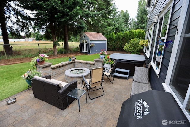 4442 Prestwick Ln SE, Lacey, WA 98513 - fenced backyard featuring a hot tub, a patio, an outdoor fire pit, and a storage shed