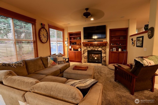 4442 Prestwick Ln SE, Lacey, WA 98513 - living room featuring ceiling fan, carpet flooring, a fireplace, and built in features