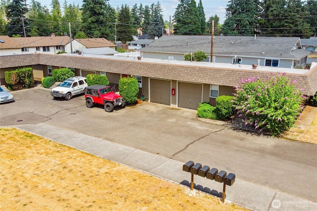 617-619 140th St S, Tacoma, WA 98444 - view of building exterior featuring a garage, a residential view, and driveway