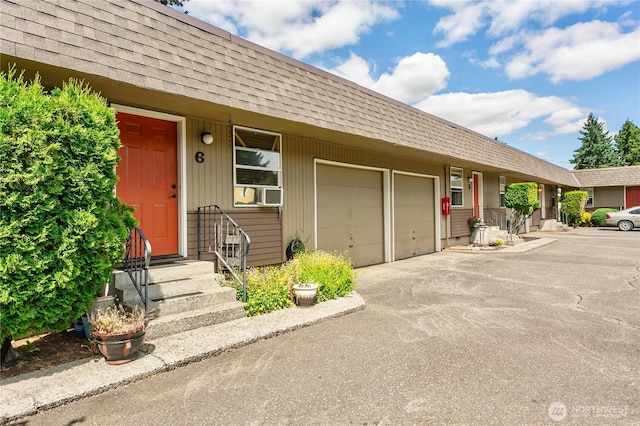 617-619 140th St S, Tacoma, WA 98444 - view of front facade with a shingled roof, driveway, mansard roof, and an attached garage