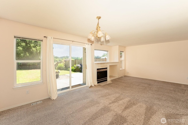 527 Cypress Ave, Snohomish, WA 98290 - unfurnished living room featuring carpet floors, a chandelier, and a fireplace with flush hearth