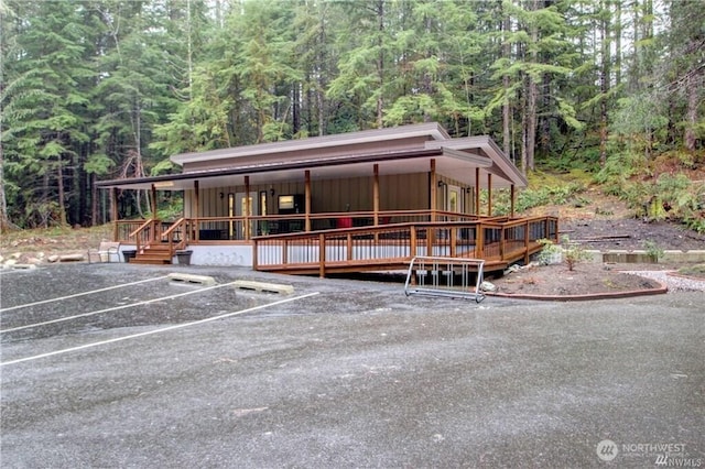 35 Branch Cir, Deming, WA 98244 - view of front of house featuring a forest view, uncovered parking, and a wooden deck