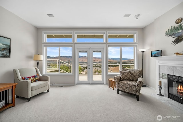 591 Daniels Dr NE, East Wenatchee, WA 98802 - living area featuring carpet floors, a fireplace, a mountain view, and french doors