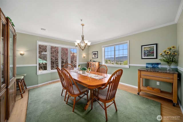 591 Daniels Dr NE, East Wenatchee, WA 98802 - dining area featuring a chandelier, light wood-type flooring, and ornamental molding