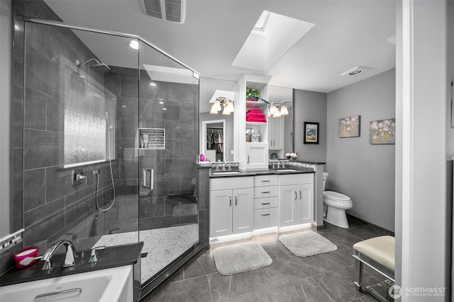 591 Daniels Dr NE, East Wenatchee, WA 98802 - bathroom featuring a shower stall, double vanity, a skylight, a tub, and recessed lighting