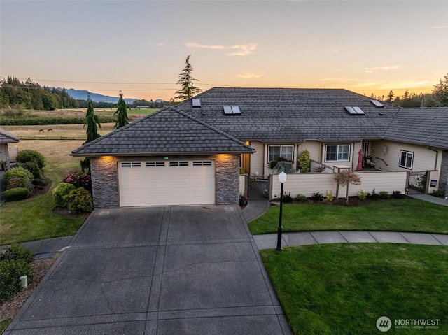 120 Cascadia Loop, Sequim, WA 98382 - view of front facade with driveway, a garage, a gate, and stone siding