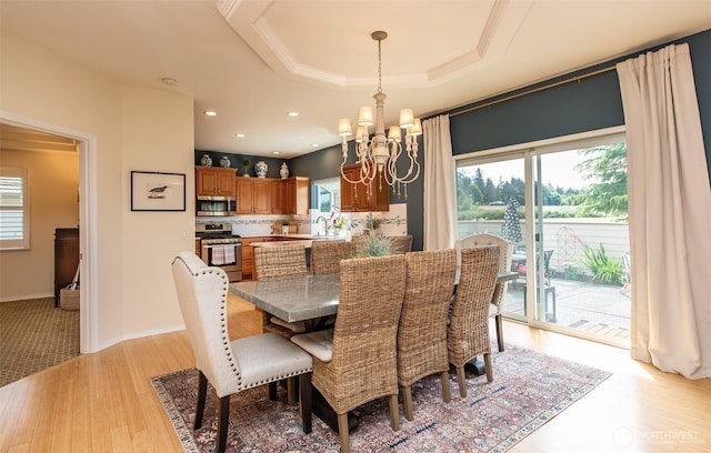 120 Cascadia Loop, Sequim, WA 98382 - dining room featuring a chandelier, healthy amount of natural light, a raised ceiling, and light wood finished floors