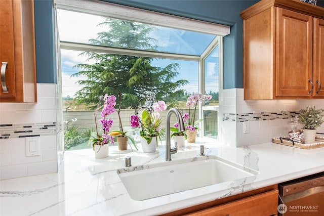 120 Cascadia Loop, Sequim, WA 98382 - kitchen with dishwashing machine, decorative backsplash, and brown cabinetry