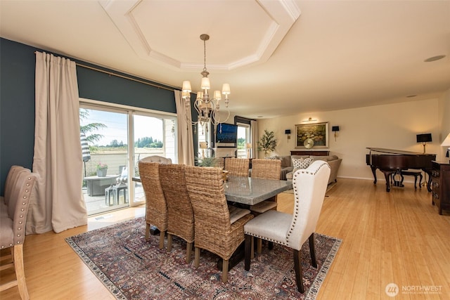 120 Cascadia Loop, Sequim, WA 98382 - dining area with light wood finished floors, a chandelier, and a tray ceiling