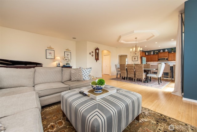 120 Cascadia Loop, Sequim, WA 98382 - living area with a chandelier, dark wood-style flooring, arched walkways, and recessed lighting