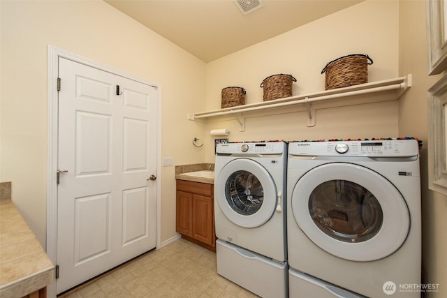 120 Cascadia Loop, Sequim, WA 98382 - washroom with washer and clothes dryer, cabinet space, and light floors