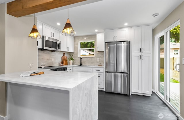 1816 N 155th St, Shoreline, WA 98115 - kitchen with appliances with stainless steel finishes, plenty of natural light, a peninsula, decorative backsplash, and recessed lighting