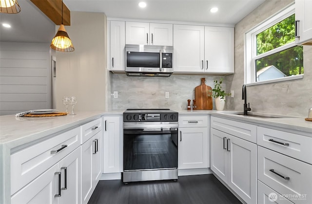 1816 N 155th St, Shoreline, WA 98115 - kitchen with stainless steel appliances, light countertops, white cabinets, dark wood finished floors, and decorative backsplash