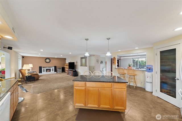 4610 N Defiance St, Tacoma, WA 98407 - kitchen with tile patterned flooring, dishwasher, recessed lighting, hanging light fixtures, and dark stone counters