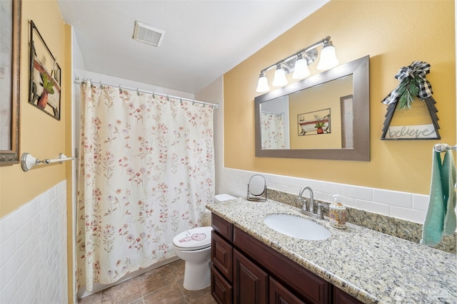4610 N Defiance St, Tacoma, WA 98407 - full bath with vanity, tile walls, a shower with shower curtain, a wainscoted wall, and tile patterned flooring