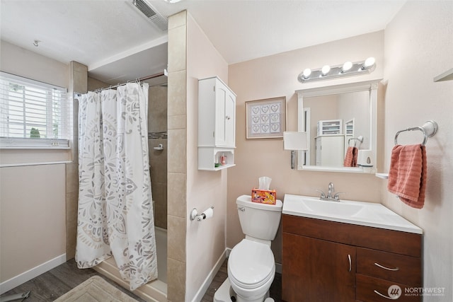 4610 N Defiance St, Tacoma, WA 98407 - full bathroom with vanity, curtained shower, and wood finished floors