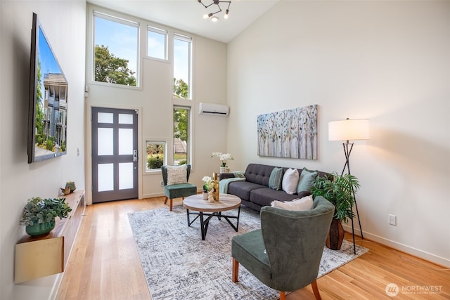 140 26th Ave E, Seattle, WA 98112 - living area featuring a towering ceiling, healthy amount of natural light, a wall mounted air conditioner, and light wood-type flooring