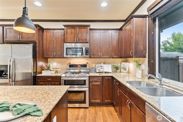 16128 120th Ave NE, Bothell, WA 98011 - kitchen with appliances with stainless steel finishes, light stone counters, hanging light fixtures, recessed lighting, and ornamental molding