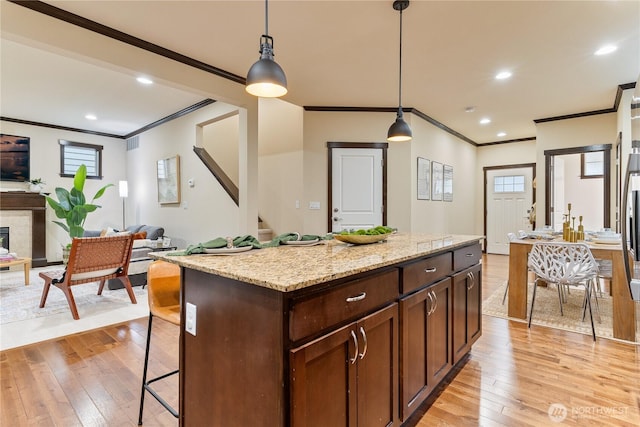 16128 120th Ave NE, Bothell, WA 98011 - kitchen featuring crown molding, light wood finished floors, open floor plan, pendant lighting, and a center island
