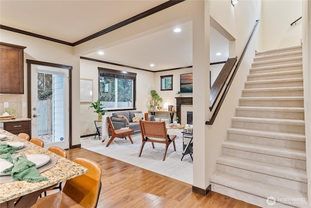 16128 120th Ave NE, Bothell, WA 98011 - living area with stairway, light wood-style floors, crown molding, a glass covered fireplace, and recessed lighting