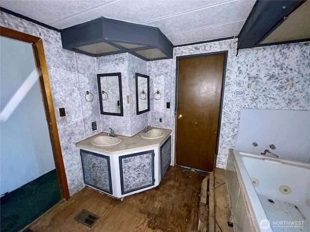 1201 S 2nd St, Dayton, WA 99328 - bathroom with a tub with jets, double vanity, and wallpapered walls