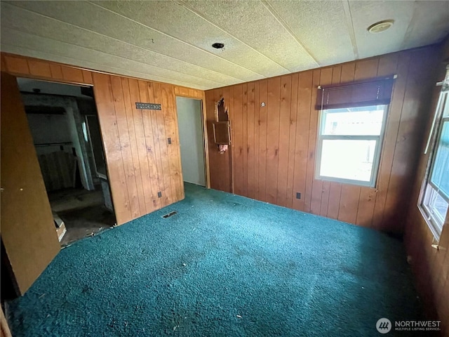 1201 S 2nd St, Dayton, WA 99328 - spare room featuring wood walls and carpet floors