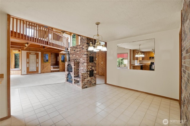 31312 179th Pl SE, Auburn, WA 98092 - unfurnished living room featuring a chandelier, healthy amount of natural light, a textured ceiling, ceiling fan, and a fireplace