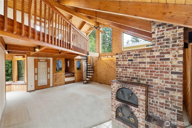 31312 179th Pl SE, Auburn, WA 98092 - unfurnished living room featuring wooden walls, ceiling fan, carpet, and a wooden ceiling with exposed beams