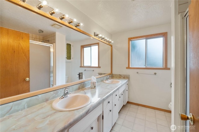 31312 179th Pl SE, Auburn, WA 98092 - bathroom with double vanity, a textured ceiling, a stall shower, and tile patterned floors