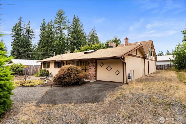 31312 179th Pl SE, Auburn, WA 98092 - view of front facade featuring a chimney, an attached garage, and driveway