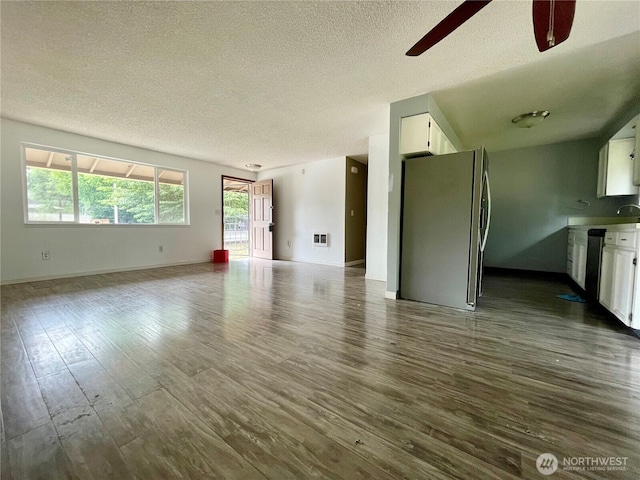 4301 NE 137th Ave, Vancouver, WA 98682 - unfurnished living room featuring a textured ceiling, a ceiling fan, and dark wood finished floors