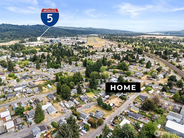 1428 S 4th Ave, Kelso, WA 98626 - aerial overview of property's location featuring a mountain backdrop and nearby suburban area