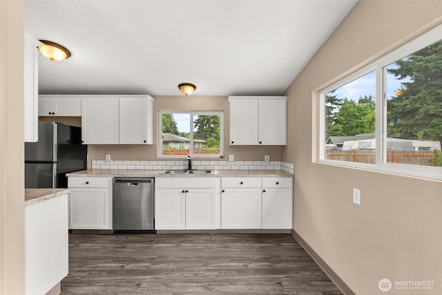 1428 S 4th Ave, Kelso, WA 98626 - kitchen featuring stainless steel appliances, white cabinets, dark wood-style flooring, and light stone countertops