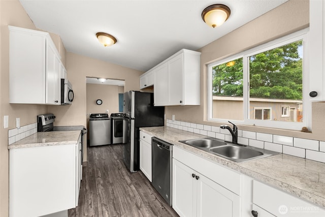 1428 S 4th Ave, Kelso, WA 98626 - kitchen with independent washer and dryer, appliances with stainless steel finishes, light countertops, white cabinets, and vaulted ceiling