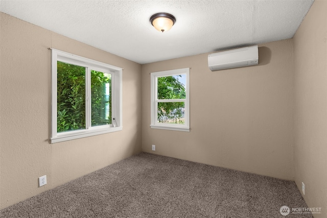 1428 S 4th Ave, Kelso, WA 98626 - unfurnished room with a wall mounted AC, carpet, and a textured ceiling
