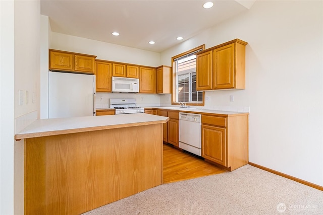 114 Twin Sister Loop, Lynden, WA 98264 - kitchen featuring white appliances, a peninsula, recessed lighting, light colored carpet, and light countertops