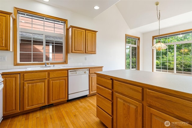 114 Twin Sister Loop, Lynden, WA 98264 - kitchen featuring white dishwasher, light countertops, light wood-type flooring, brown cabinetry, and vaulted ceiling