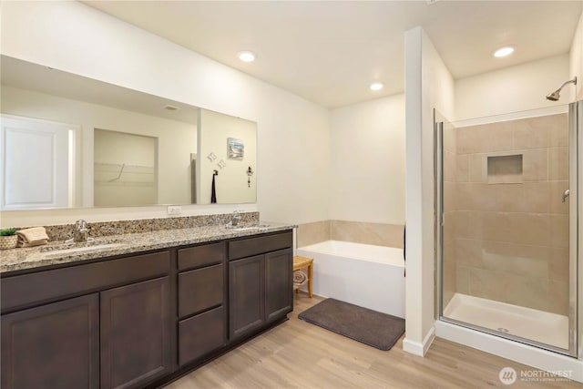 28515 76th Dr NW, Stanwood, WA 98292 - bathroom featuring a shower stall, a garden tub, double vanity, wood finished floors, and recessed lighting