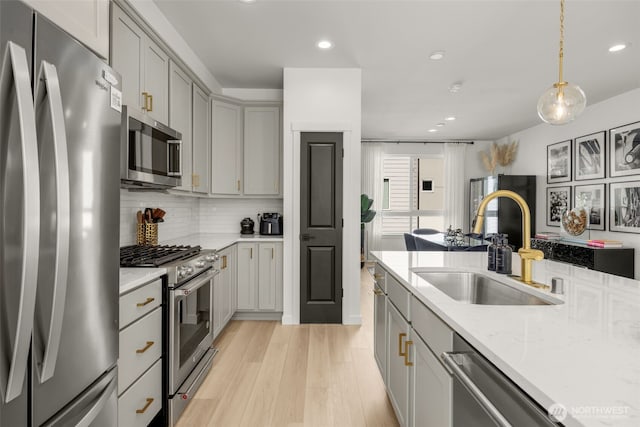 14646 35th Ct NE, Lake Forest Park, WA 98155 - kitchen featuring appliances with stainless steel finishes, gray cabinets, backsplash, light wood-type flooring, and recessed lighting