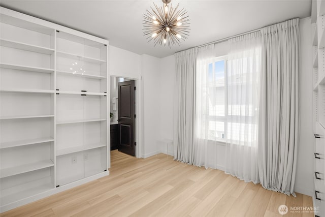 14646 35th Ct NE, Lake Forest Park, WA 98155 - unfurnished bedroom with a chandelier and light wood-style floors
