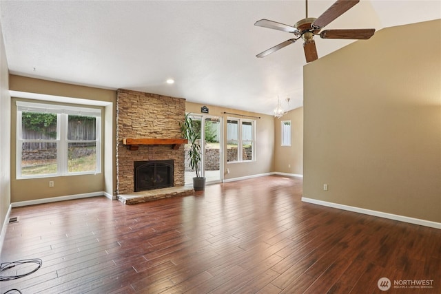 13940 113th Ave NE, Kirkland, WA 98034 - unfurnished living room featuring ceiling fan, a stone fireplace, a chandelier, wood finished floors, and vaulted ceiling